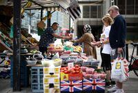 FILE PHOTO: : A person buys produce from a fruit and vegetable market stall in central London, Britain, August 19, 2022. REUTERS/Henry Nicholls/File Photo