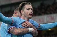 Manchester City's Jack Grealish celebrates after scoring his side's second goal during the English Premier League soccer match between Arsenal and Manchester City at the Emirates stadium in London, England, Wednesday, Feb.15, 2023. (AP Photo/Kin Cheung)