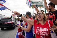Cuban exiles rally at Versailles Restaurant in Miami's Little Havana neighborhood in support of protesters in Cuba, Monday, July 12, 2021, in Miami. Sunday's protests in Cuba marked some of the biggest displays of antigovernment sentiment in the tightly controlled country in years. Cuba is going through its worst economic crisis in decades, along with a resurgence of coronavirus cases, as it suffers the consequences of U.S. sanctions imposed by former President Donald Trump's administration. (AP Photo/Marta Lavandier)