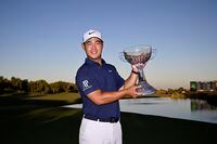 LAS VEGAS, NEVADA - OCTOBER 15: Tom Kim of South Korea poses with the trophy after putting in to win on the 18th green during the final round of the Shriners Children's Open at TPC Summerlin on October 15, 2023 in Las Vegas, Nevada. (Photo by Orlando Ramirez/Getty Images)
