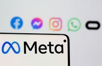 FILE PHOTO: Facebook's new rebrand logo Meta is seen on smartphone in front of displayed logo of Facebook, Messenger, Instagram, Whatsapp and Oculus in this illustration picture taken October 28, 2021. REUTERS/Dado Ruvic/Illustration/File Photo