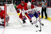 Montreal Canadiens' Nick Suzuki (14) controls the puck behind the Carolina Hurricanes net during the third period of an NHL hockey game in Raleigh, N.C., Thursday, Dec. 30, 2021. (AP Photo/Karl B DeBlaker)