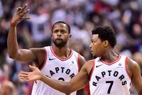 Toronto Raptors forward CJ Miles (0) and Raptors guard Kyle Lowry (7) celebrate a basket against the Washington Wizards during second half round one NBA playoff basketball action in Toronto on Saturday, April 14, 2018. THE CANADIAN PRESS/Frank Gunn