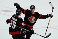 Ottawa Senators defenceman Jake Sanderson races to congratulate right wing Alex DeBrincat on his game winning goal in overtime against the Philadelphia Flyers, Thursday, March 30, 2023 in Ottawa.  THE CANADIAN PRESS/Adrian Wyld