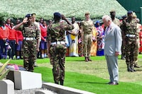 Britain's King Charles III prepares to lay a wreath, during a visit to Kariokor World War II Commonwealth Cemetery in Nairobi, Kenya, Wednesday, Nov. 1, 2023. King Charles III has visited a war cemetery in Kenya, laying a wreath in honor of Kenyans who fought alongside the British in the two world wars. It came a day after the British monarch expressed “greatest sorrow and the deepest regret” for the violence of the colonial era. He gave replacement medals to four war veterans. (Tony Karumba/Pool Photo via AP)