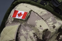 <p>A Canadian flag patch is shown on a soldier's shoulder in Trenton, Ont., on Thursday, Oct. 16, 2014. A group from the Canadian Armed Forces have been deployed to Jamaica to train Caribbean Community troops for a mission in Haiti. A news release from National Defence says 70 armed forces members were deployed on Friday at the request of the Jamaican government. THE CANADIAN PRESS/Lars Hagberg</p>