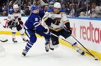Toronto Maple Leafs defenceman Simon Benoit (2) battles with St. Louis Blues forward Brayden Schenn (10) during third period NHL hockey action in Toronto on Tuesday, February 13, 2024. The Maple Leafs have signed Benoit to a three-year contract extension.THE CANADIAN PRESS/Nathan Denette