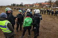 Police officers detain a Greenpeace activist, as activists demonstrate at Luetzerath, a village that is about to be demolished to allow for the expansion of the Garzweiler open-cast lignite mine of Germany's utility RWE, Germany, January 10, 2023. REUTERS/Wolfgang Rattay