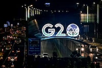 Vehicles drive past the logo of India's G20 summit, along a road in New Delhi on August 10, 2023. (Photo by Sajjad HUSSAIN / AFP) (Photo by SAJJAD HUSSAIN/AFP via Getty Images)