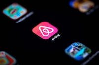 (FILES) In this file photo illustration taken on November 22, 2019 shows the logo of the online lodging service Airbnb displayed on a smartphone in Paris. - Airbnb on February 14, 2023 reported its first annual profit, with revenue surging in the final three months of 2022 as travel bookings rebounded. The home-rental platform said it made a profit of $319 million in the final quarter of last year on revenue of nearly $2 billion. (Photo by Lionel BONAVENTURE / AFP) (Photo by LIONEL BONAVENTURE/AFP via Getty Images)