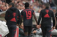 Bayern's Alphonso Davies leaves the pitch after an injury during the German Bundesliga soccer match between 1. FSV Mainz 05 and FC Bayern Munich at the Mewa Arena in Mainz, Germany, Saturday, April 22, 2023. (AP Photo/Matthias Schrader)