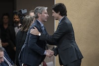 <p>Prime Minister Justin Trudeau, right, is greeted by Nova Scotia Premier Tim Houston in Truro, N.S. on Thursday, March 30, 2023. <i>Houston </i>has joined a call from leaders across the country asking for a meeting with Trudeau about carbon pricing. THE CANADIAN PRESS/Darren Calabrese</p>