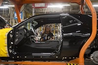 An employee works on vehicle production at a conveyor belt at the FCA Brampton Assembly Plant in Ont., on Friday, July 21, 2023. Tijana Martin/ The Globe and Mail