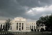 FILE PHOTO: Storm clouds gather over the U.S. Federal Reserve Building before an evening thunderstorm in Washington June 9, 2006. REUTERS/Jim Bourg/File Photo