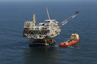 FILE - A rig and supply vessel are pictured in the Gulf of Mexico, off the cost of Louisiana, April 10, 2011. An auction of federal Gulf of Mexico leases for oil and gas drilling must be held in 37 days, a federal appeals court ruled Tuesday, Nov. 14, 2023, rejecting environmentalists arguments against the sale, and throwing out plans by the Biden administration to scale back the sale to protect an endangered species of whale. (AP Photo/Gerald Herbert, File)