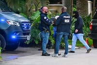 Federal and Homeland Security Investigation agents are seen at the entrance of US producer and musician Sean "Diddy" Combs's home at Star Island in Miami Beach on March 25, 2024. Homes belonging to Sean "Diddy" Combs were being raided by federal agents, media reported on March 25, with the US hip hop mogul at the center of sex trafficking and sex assault lawsuits. (Photo by GIORGIO VIERA / AFP) (Photo by GIORGIO VIERA/AFP via Getty Images)