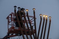 Officials and Jewish leaders are calling on councillors in a city in New Brunswick to reverse their decision against displaying a menorah, marking the start of Hanukkah at sundown this Thursday. A Rabbi lights a giant menorah for Hanukkah in Edmonton, Thursday, Dec. 17, 2020. THE CANADIAN PRESS/Jason Franson