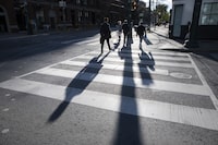 Pedestrians crossing Spadina Ave. while walking on King St. West in downtown Toronto, are photographed on Oct 18, 2021. Fred Lum/The Globe and Mail. 
