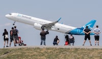 The risk of a strike at Air Transat has lifted as flight attendants have voted in favour of a new collective agreement. People look on as an Air Transat plane takes off at Trudeau in Montreal, Sunday, June 11, 2023. THE CANADIAN PRESS/Graham Hughes