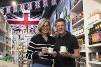 Rita and Carl Hulme stand with King Charles merchandise at Blimeys British Store and Gift Shop in Essex, Ont. on Sunday, April 16, 2023. THE CANADIAN PRESS/Nicole Osborne