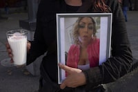 A member of the LGBTQ+ community holds a portrait of transgender activist Samantha Gomes Fonseca during a rally to protest her murder in Mexico City, Monday, Jan. 15, 2024. Gomes was shot in Mexico City Sunday. (AP Photo/Marco Ugarte)