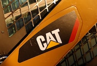 FILE PHOTO: The CAT logo is seen on the side of a Caterpillar machine on a lot at Milton CAT in North Reading, Massachusetts January 23, 2013. REUTERS/Jessica Rinaldi (UNITED STATES - Tags: BUSINESS CONSTRUCTION LOGO)/File Photo