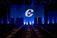A man is silhouetted walking past a Conservative Party logo before the opening of the party's national convention in Halifax on Thursday, August 23, 2018. The Conservative party's first openly trans candidate says she wasn't surprised delegate voted against gender-affirming care but warns of harm "the transphobic language" could cause if it becomes a law. THE CANADIAN PRESS/Darren Calabrese