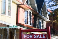 The Canadian Real Estate Association says home sales rose in December as the average price of a home sold also saw a boost compared with a year earlier. A real estate sign is displayed in front of a house in Toronto on Wednesday, September 29, 2021. THE CANADIAN PRESS/Evan Buhler