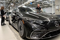 (FILES) Employees of German car maker Mercedes-Benz work on an EQS passenger car at the 'Factory 56', a completely digitized assembly line, at the Mercedes-Benz manufacturing plant in Sindelfingen, southwestern Germany, on February 13, 2023. German carmaker Mercedes-Benz raised its forecast for the current year in the evening of July 26, 2023, with operating profit now expected at the same level as 2022, and no longer slightly down. In the second quarter, the group generated an operating profit (EBIT) of 5 billion euros, higher than the expectations of analysts who counted in their consensus on 4.7 billion euros, in particular thanks to the performance of the Mercedes Vans sector, he said in a press release. (Photo by THOMAS KIENZLE / AFP) (Photo by THOMAS KIENZLE/AFP via Getty Images)