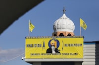 FILE PHOTO: A banner with the image of Sikh leader Hardeep Singh Nijjar is seen at the Guru Nanak Sikh Gurdwara temple, site of his June 2023 killing, in Surrey, British Columbia, Canada September 20, 2023. REUTERS/Chris Helgren