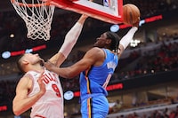 CHICAGO, ILLINOIS - OCTOBER 25: Jalen Williams #8 of the Oklahoma City Thunder attempts a dunk over Nikola Vucevic #9 of the Chicago Bulls during the first half at the United Center on October 25, 2023 in Chicago, Illinois. NOTE TO USER: User expressly acknowledges and agrees that, by downloading and or using this photograph, User is consenting to the terms and conditions of the Getty Images License Agreement. (Photo by Michael Reaves/Getty Images)