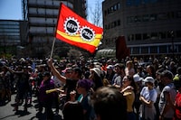 Members of the Public Service Alliance of Canada (PSAC) watch a performance as they picket outside Place du Portage in Gatineau, Que., as workers from Canada's largest federal public-service union remain on strike across the country, on Friday, April 28, 2023. THE CANADIAN PRESS/Justin Tang