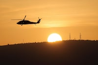 An Israeli military helicopter flies over Northern Israel near the border with Lebanon November 2, 2023. REUTERS/Violeta Santos Moura/ File Photo