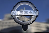 FILE - A Nissan logo is seen on a car at its showroom in Tokyo, Feb. 21, 2023. Nissan is recalling more than 809,000 small SUVs in the U.S. and Canada, Tuesday, Feb. 28, because a key problem can cause the ignition to shut off while they’re being driven. The recall covers Rogues from the 2014 through 2020 model years, as well as Rogue Sports from 2017 through 2022. (AP Photo/Shuji Kajiyama, File)