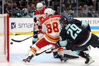 SEATTLE, WASHINGTON - NOVEMBER 20: Andrew Mangiapane #88 of the Calgary Flames scores against the Seattle Kraken during the third period at Climate Pledge Arena on November 20, 2023 in Seattle, Washington. (Photo by Steph Chambers/Getty Images)