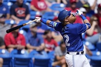 Toronto Blue Jays designated hitter Justin Turner (2) watches a fly ball in the first inning of a spring training baseball game against the Philadelphia Phillies Monday, March 4, 2024, in Dunedin, Fla. (AP Photo/Charlie Neibergall)