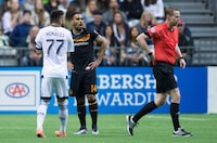 Houston Dynamo's Alex, second left, and Vancouver Whitecaps' Pedro Morales, left, react after both received red cards from referee Drew Fischer during the first half of an MLS soccer game in Vancouver on Saturday May 28, 2016. Canadian Fischer is one of 21 FIFA referees appointed to work the football tournament at this summer's Paris Olympics.THE CANADIAN PRESS/Darryl Dyck