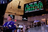 Traders work on the floor of the New York Stock Exchange during afternoon trading on March 27.