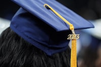 <div>Ontario's colleges want the province to immediately end its five-year-long tuition freeze. A tassel with 2023 on it rests on a graduation cap as students walk in a procession for Howard University's commencement in Washington, Saturday, May 13, 2023. THE CANADIAN PRESS/AP/Alex Brandon</div>