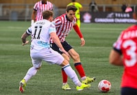 Pacific FC's Josh Heard, left, and Atletico Ottawa's Maxim Tissot battle for the ball during the first leg of their Canadian Championship quarterfinal match in Ottawa in this Wednesday, May 8, 2024 handout photo. THE CANADIAN PRESS/HO, Tim Austen, Freestyle Photography *MANDATORY CREDIT*
