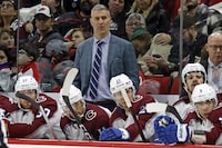 FILE - Colorado Avalanche head coach Jared Bednar, top center, watches from behind the bench during the third period of an NHL hockey game against the Carolina Hurricanes in Raleigh, N.C., Thursday, Nov. 17, 2022. Colorado Avalanche coach Jared Bednar signed a three-year contract extension that will keep him in charge of the reigning Stanley Cup champions through the 2026-27 season. The team announced the new deal Tuesday, March 21, 2023. (AP Photo/Karl B DeBlaker, File)