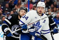 Toronto Maple Leafs' Auston Matthews (34) and Tampa Bay Lightning's Brandon Hagel (38) watch the play during first period NHL hockey action in Tampa, Fla. on Wednesday, April 17, 2024. THE CANADIAN PRESS/Frank Gunn