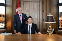 Prime Minister Justin Trudeau, right, sits behind the desk of former prime minister Brian Mulroney, left, while touring a replica of Mr. Mulroney's former parliamentary office in Mulroney Hall at St. Francis Xavier University in Antigonish, N.S. on Monday, June 19, 2023. THE CANADIAN PRESS/Darren Calabrese