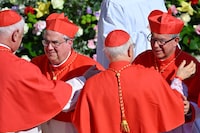 Newly elevated cardinals, archbishop from Cordoba Angel Sixto Rossi (L) and archbishop from Bogota in Colombia Luis Jose Rueda Aparicio (R) are congratulated by fellow cardinals at the end of a consistory to create 21 new cardinals at St. Peter's square in The Vatican on September 30, 2023. Pope Francis elevates 21 clergymen from all corners of the world to the rank of cardinal -- most of whom may one day cast ballots to elect his successor. (Photo by Filippo MONTEFORTE / AFP) (Photo by FILIPPO MONTEFORTE/AFP via Getty Images)