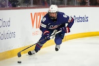 United States defender Haley Winn skates with the puck against Canada during the first period of a rivalry series women's hockey game Wednesday, Nov. 8, 2023, in Tempe, Ariz. (AP Photo/Ross D. Franklin)