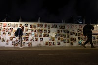 People walk past posters with images of hostages kidnapped in the deadly October 7 attack on Israel by the Palestinian Islamist group Hamas from Gaza, as the conflict between Israel and Hamas continues, in Tel Aviv, Israel, April 10, 2024. REUTERS/Hannah McKay