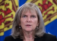 Nova Scotia Auditor General  Kim Adair answers questions at a news conference in Halifax on Tuesday, Nov. 23, 2021. Adair says the province did not exercise “appropriate” due diligence when it bought an unfinished hotel for $34.5 million last year in order to convert it into a health facility. THE CANADIAN PRESS/Andrew Vaughan