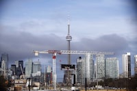 Condominiums and the CN Tower are shown along the Toronto skyline on Tuesday, April 25, 2017. The Toronto Regional Real Estate Board says the average cost for a one-bedroom condo soared by more than 20 per cent to $2,481 between the third quarter of this year and the same period last year. THE CANADIAN PRESS/Cole Burston