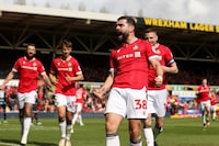 WREXHAM, WALES - APRIL 13: Elliott Lee of Wrexham celebrates scoring his team's first goal during the Sky Bet League Two match between Wrexham and Forest Green Rovers at Racecourse Ground on April 13, 2024 in Wrexham, Wales. (Photo by Charlotte Tattersall/Getty Images) (Photo by Charlotte Tattersall/Getty Images)