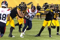 Montreal Alouettes defensive end Shawn Lemon (0) carries the ball following an interception during second half CFL football game action against the Hamilton Tiger-Cats in Hamilton, Ont. on Saturday, August 5, 2023. THE CANADIAN PRESS/Nick Iwanyshyn